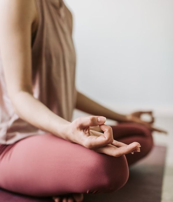 Woman in a calm, seated yoga pose, embodying inner peace.